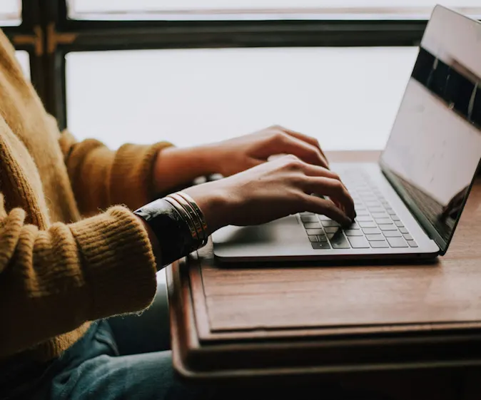 Typing on a laptop